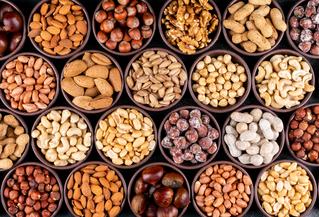 Assortment of heart-healthy nuts including almonds, walnuts, and pistachios.
