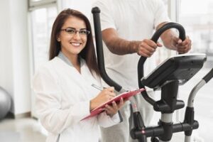 A female cardiologist observing TMT test.